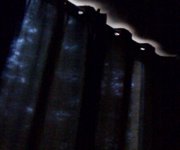 Before Magic Blackout Blind is applied to lodge windows at Center Parcs, Longleat. Thin curtains let in light, causing children to wake up early.